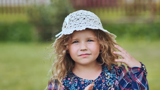 Portrait of a little girl in a panama hat on a summer day