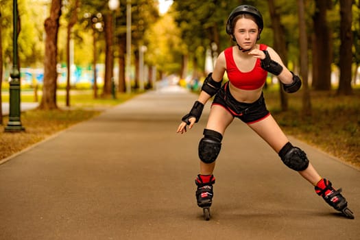 Roller skating girl in park rollerblading on inline skates. Caucasian young woman in outdoor activities