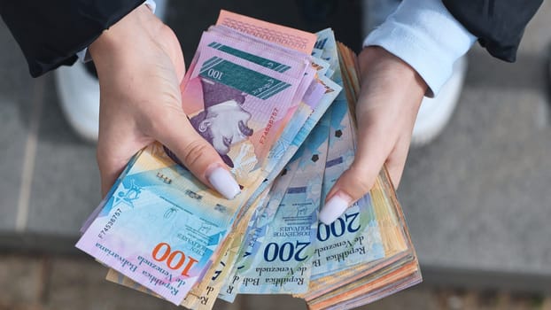 A girl counts old Venezuelan money