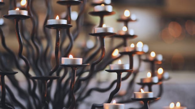 Candlestick holder with burning candles in a Catholic church