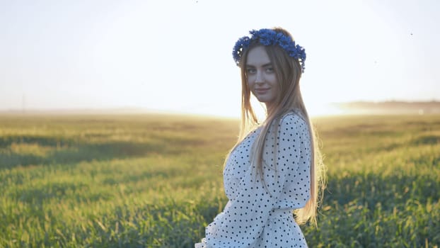 A cute Ukrainian girl posing in a field in the evening