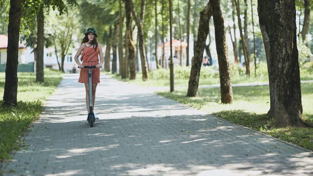 A girl rolls around on city tiles in the park