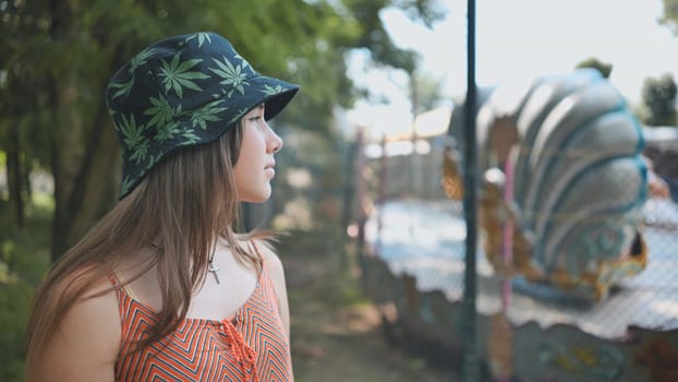 A girl looks at a working ride in a children's park