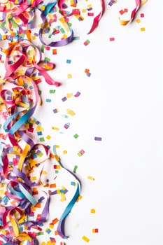 Colorful confetti and streamers on a white background.