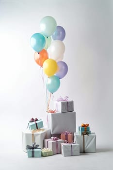 A collection of colorful balloons tied to a stack of various gift packages.