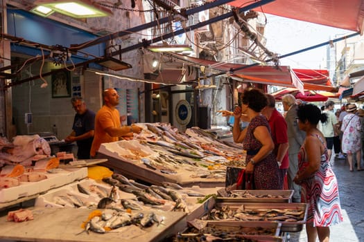 Palermo, Italy - July 20, 2023: Market stalls and people at famous and historical Capo Market