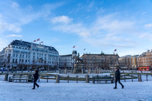 Copenhagen, Denmark - January 4, 2024: Historic Kongens Nytorv Square covered by snow during winter season.