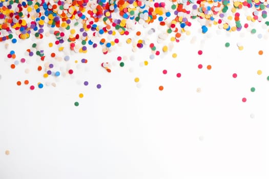 Colorful scattered confetti on a white background.