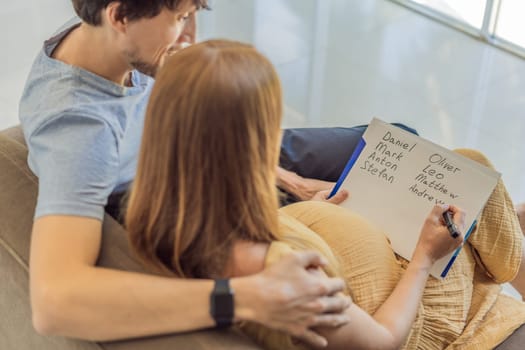 Expectant couple joyfully selects a name for their unborn son, savoring the special moment of choosing a meaningful identity for their growing family.