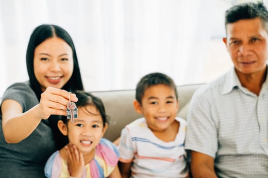 A happy family celebrates new homeownership mother proudly holding keys to their house. The image captures familial joy excitement and the promise of a new living space. New house