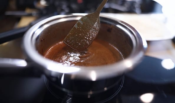 Close-up cooking caramel sauce in pan at home. Master new profession and skills cook. Proven recipes from chefs and pastry chefs. Varied breakfasts quick and easy. Learn to bake at home