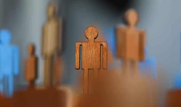 Close-up, wooden mans flat figure, political puppet. Prestigious job for people. Protection labor rights workers. Figures people for presentation wooden and plastic. Manipulative methods