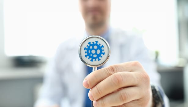 Doctor holds stethoscope infected with coronavirus. Fast-growing healthcare segment. Reduce number trips to doctor thanks to telemedicine. Determining prognosis disease during pandemic