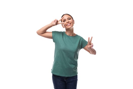 young confident slim woman dressed in a green basic t-shirt with print mockup. corporate clothing concept.