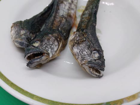 Dried goby fish in a the plate