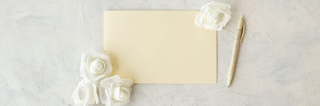 banner of top view of empty card, pen, white flowers on grey background