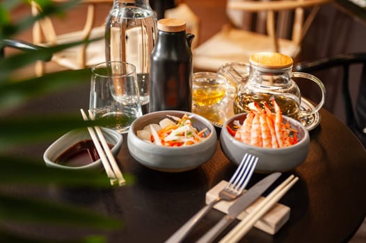 Shrimp sashimi on a plate on a table in a sushi bar on a plate close-up. High quality photo