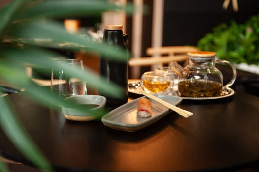 Nigiri tuna tataki on a plate on a table in a sushi bar on a plate close-up. High quality photo