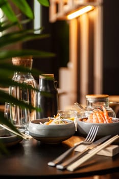 Shrimp sashimi on a plate on a table in a sushi bar on a plate close-up. High quality photo