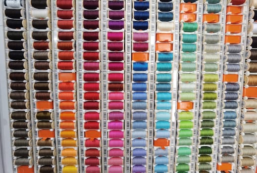 Set of multicolored threads for sewing - Many different colors sewing threads arranged in a palette. Hobby craft