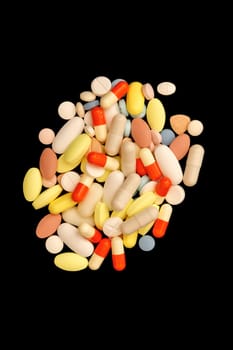 Many different colorful medications and pills. A pile of various multicolored drugs.