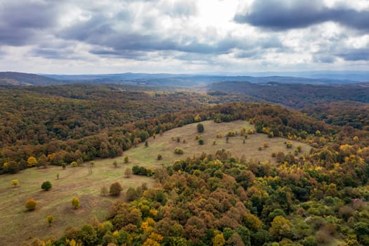 aerial view of mountain and valley covered with autumn colors	