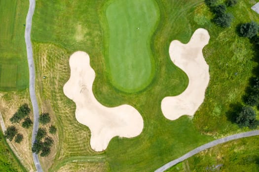 Landscape in a golf course an aerial view of a green field, lawn, and grass. Design for golfers to play games, sports, and outdoor recreation activities.