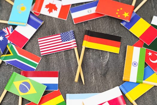 Policy. National flags of different countries. The concept is diplomacy. In the middle among the various flags are two flags - USA, Germany