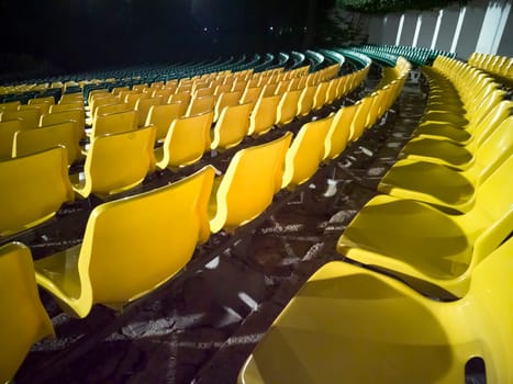 Empty chairs in the stands of the movie theater. Many empty seats for spectators. 