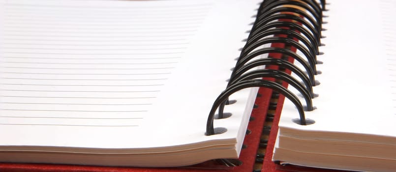 Close up of an open spiral notebook. Banner view