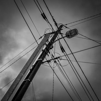 Black and white view of the intersection of numerous electrical and telephone wires, High quality photo