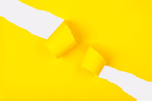 Ripped Yellow paper with curled edges. White color under the yellow paper