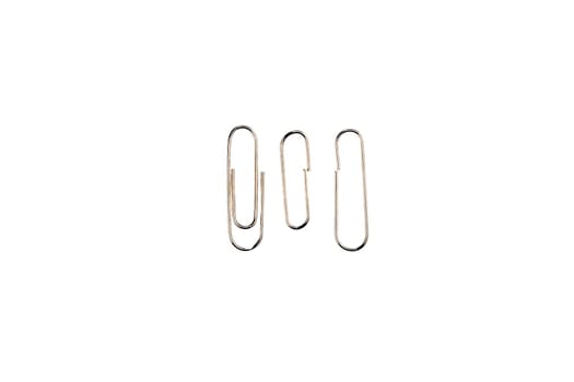metal paper clip attached to paper isolated on white background. Shiny metal paper clip, page holder, binder.