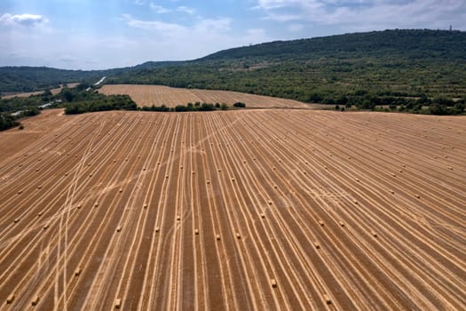 Scenic aerial view of hay bales on the field after harvest.