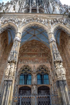 Ornate facade of famous medieval architecture, detail. The main gate of Ulm Cathedral