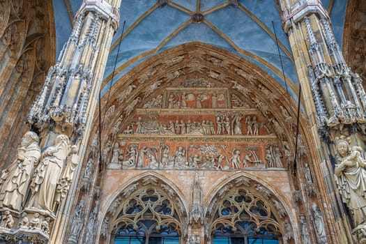 Ornate facade of famous medieval architecture, detail. The main gate of Ulm Cathedral