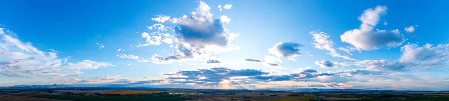 Beautiful clouds and sunlight in the sky at sunset over the land