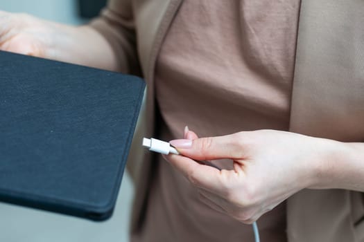 Hand holding Tablet charging power. High quality photo