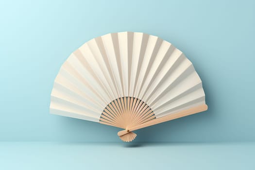 Wooden white open fan on a blue background.