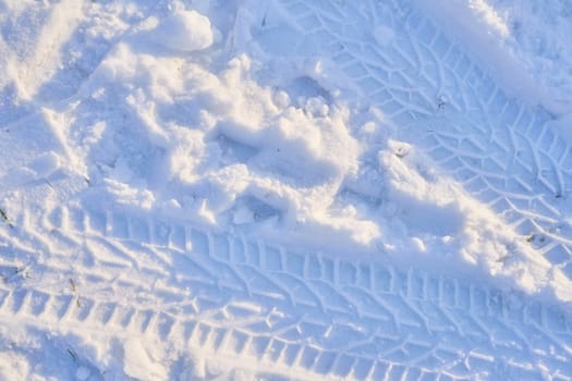 Texture of a car tire imprint on the snow.