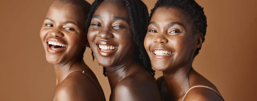 Face, beauty and laughing with black woman friends in studio on a brown background for natural wellness. Portrait, skincare and funny with a group of people looking happy at antiaging treatment.