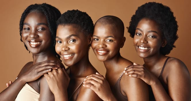 Face, beauty and smile with black woman friends in studio on a brown background for natural wellness. Portrait, skincare and happy with a group of people looking confident at antiaging treatment.