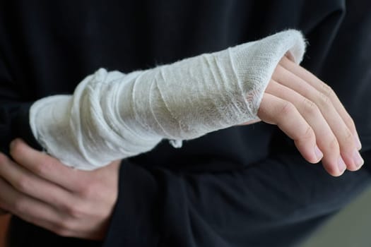 Close-up of a broken arm of a child in a cast.