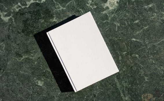 book cover mockup design. blank book mockup on green marble stone coffee table , shadow overlay