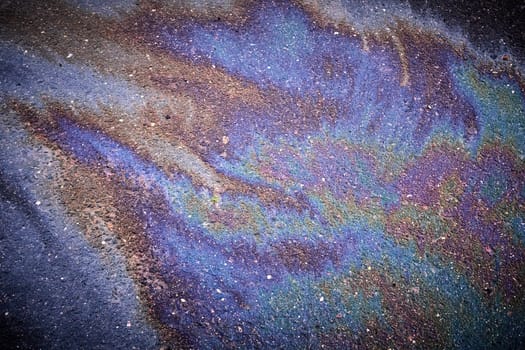 Petrol Oil Pollution Rainbow Gasoline Leak on Pavement.