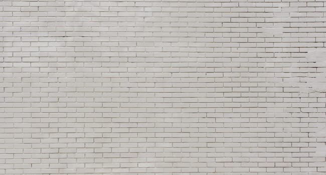 Close-up shot of a grey brick wall. Abandoned wall of a brick building.