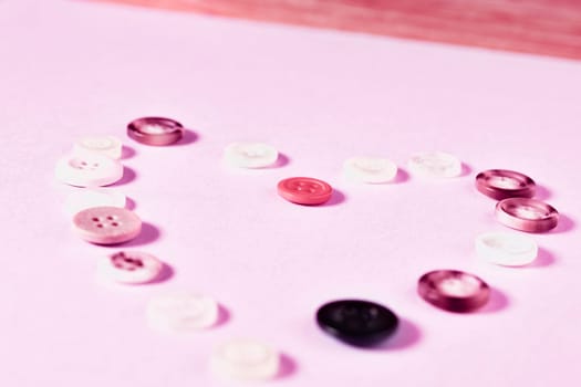 Colored buttons forming heart shape on colored background , passion and love ,Valentine's day