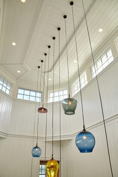 Modern interior design featuring pendant lights in a vaulted ceiling room, showcasing luxury living in a 2015 residential architecture, Coldwater, Michigan