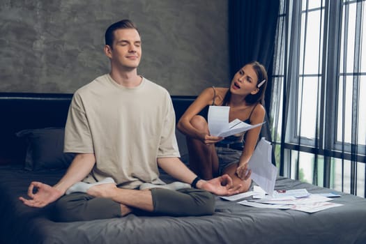 Young man doing mindfulness and peacefulness meditation ignoring problem while his wife or lover yelling with frustrated and upset expression. Marriage problem ignorant lifestyle. Unveiling