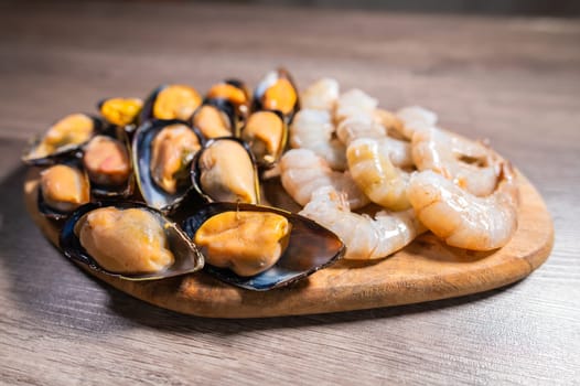 Close-up of cooked mussels. boiled black mussels in shell shell with shrimps, appetizer or snack.